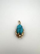 14kt yellow gold pendant set with turquoise and pearls.
The pendant is beautifully finished with gol