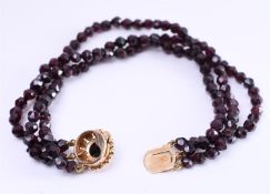 14 kt rose gold bracelet with 3 strands of faceted garnet beads and rose cut garnet gemstones. The b