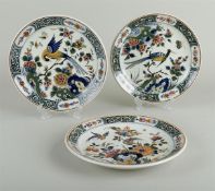 A set of three polychrome painted earthenware plates with decoration of various birds and flowers. D