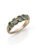 A riviere ring with green beryls