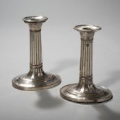 A PAIR OF SILVERPLATED CANDLESTICKS