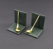 A PAIR OF BOOKENDS WITH GOLD RACKETS