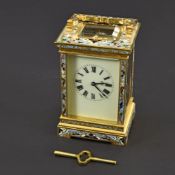 A BRASSGILT AND ENAMEL TRAVELLERS CLOCK