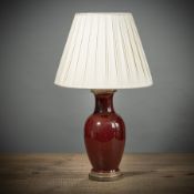 A COPPER-RED BALUSTER VASE MOUNTED AS A LAMP