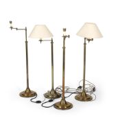 A SET OF FOUR BRASS FLOOR LAMPS