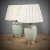A PAIR OF CARVED LOTUS RELIEF CELADON VASES MOUNTED AS LAMPS