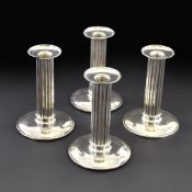 A SET OF FOUR CANDLESTICKS