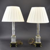 A pair of gilt bronze and glass table lamps