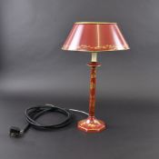 A RED LACQUERE AND PAINTED TIN TABLE LAMP