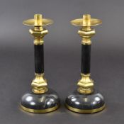 A pair of gilt brass and black marble candlesticks