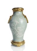 A CELADON VASE WITH 'SLIP' DECORATION OF BIRDS AND FLOWERING BRANCHES IN A MAGNIFICENT ORMOLU MOUNT