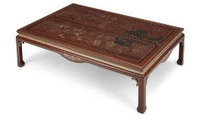 A RED LACQUERED LOW TABLE WITH INSET FLORAL AND BIRD PANELS