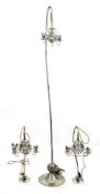 A glass and white metal floor lamp and two table lamps