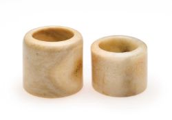 □ TWO CHINESE HARD STONE ARCHERS RINGS, QING DYNASTY, 19TH CENTURY
