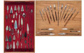 TWO DISPLAYS OF ARROWHEADS, FOUR COPPER ALLOY ARROWHEADS AND A QUIVER, POSSIBLY TIBETAN