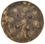 AN ASIAN CIRCULAR HIDE SHIELD, 19TH CENTURY, POSSIBLY BHUTAN