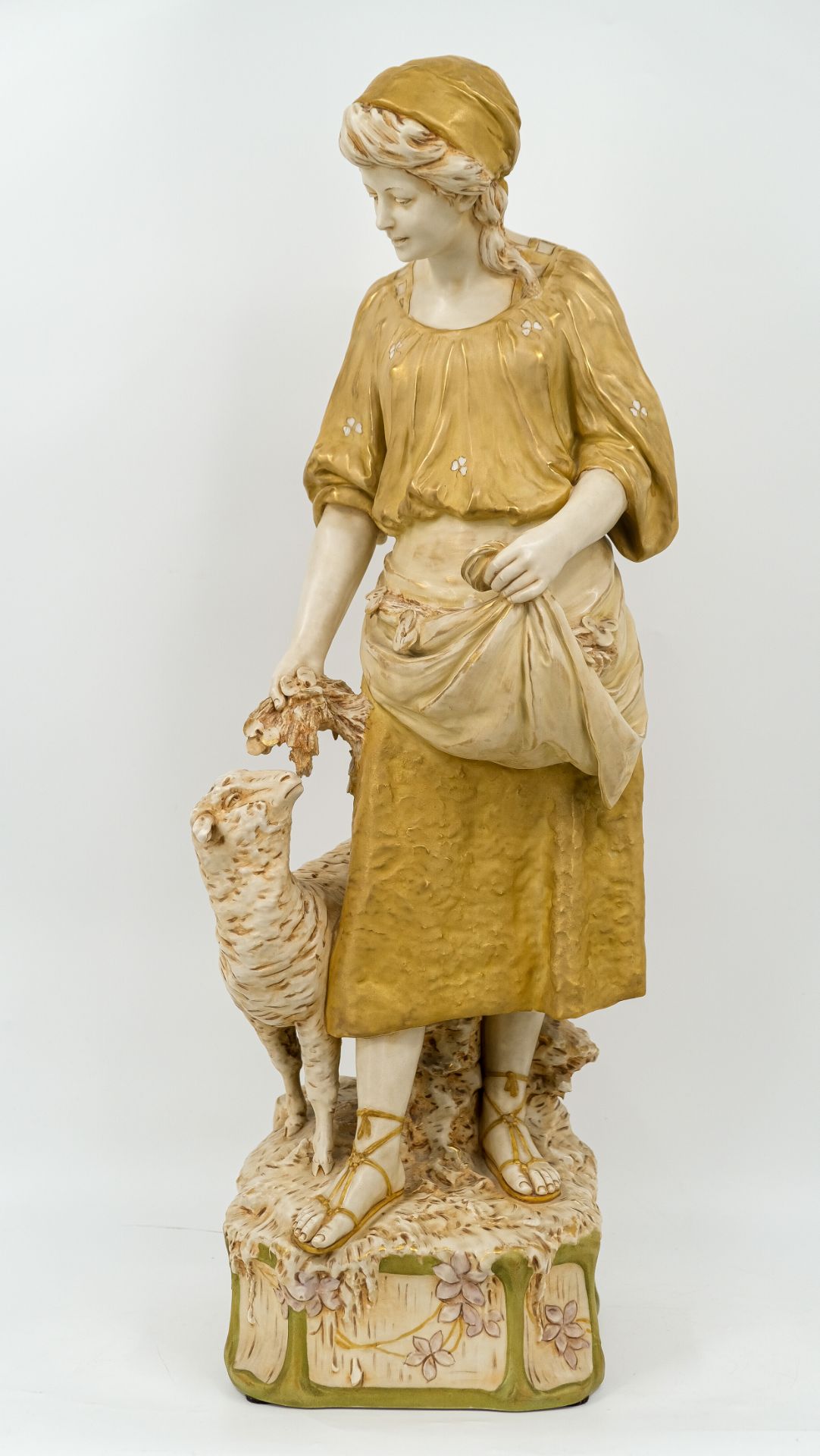 A large Bohemian Royal Dux glazed porcelain figure group of a lady and sheep