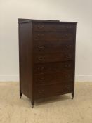 An early 20th century stained and varnished mahogany chest, the ledge back above seven drawers,