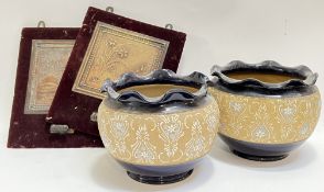 A pair of velvet backed sconces (one missing holder) with embossed panel designs of flowers and a