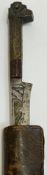 A North African Flyssa long knife with leather/hide scabbard, the blade with engraved design in