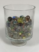 Property of the late Countess Haig, a clear cylinder stemmed vase containing a large collection of