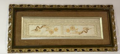 A linen work decorative panel, with hand-sticked floral sprays and lace boarder, in a wooden