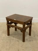 A Chinese elm low table, mid 20th century, the panelled top above a moulded frieze and turned