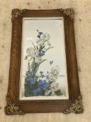 An early 20th century oak and moulded composition framed wall hanging mirror, the bevelled mirror