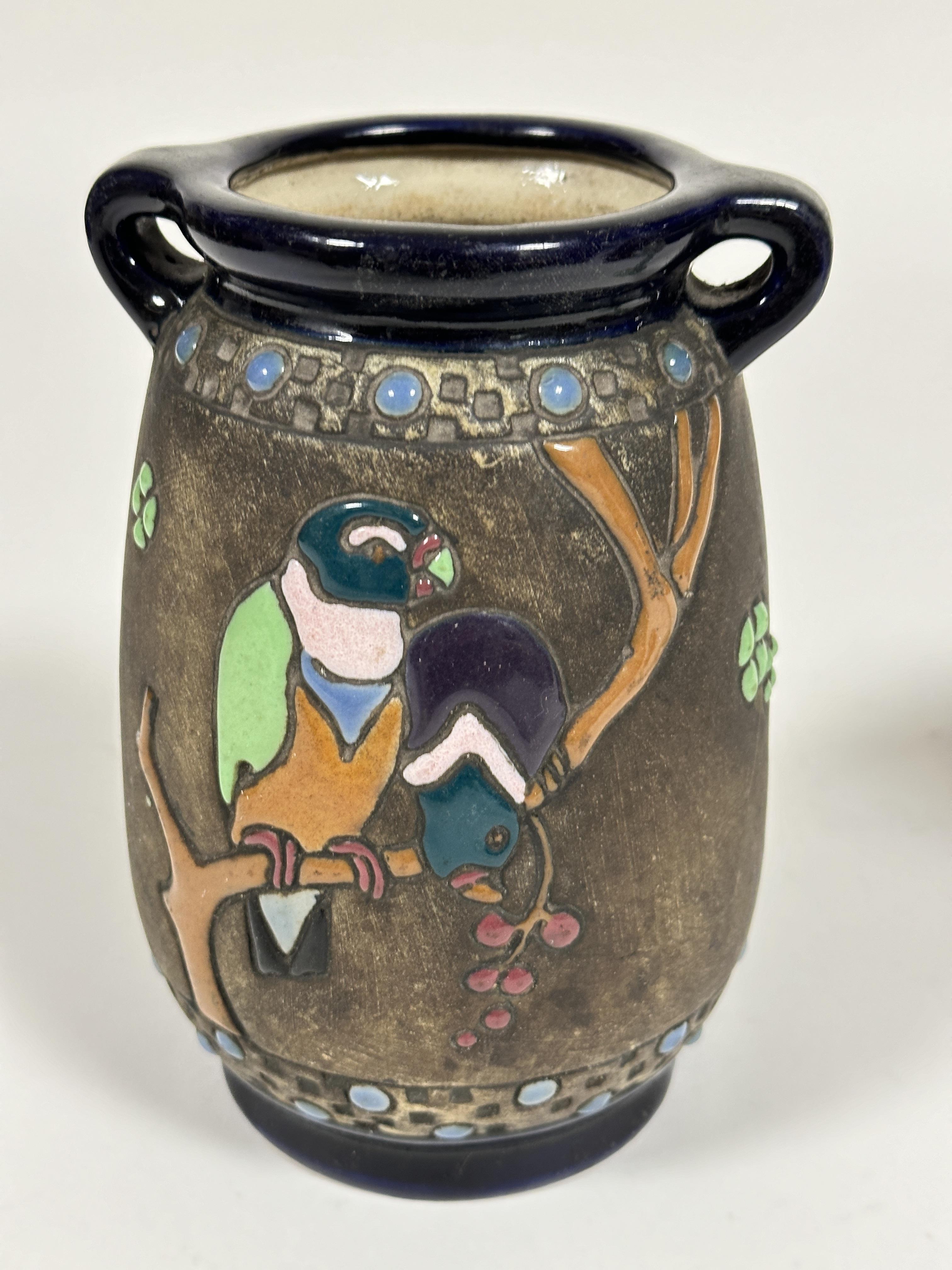 A Austrian Amphora pottery twin handled impress vase of tapered form with enamel parrot,  flowers - Image 2 of 4