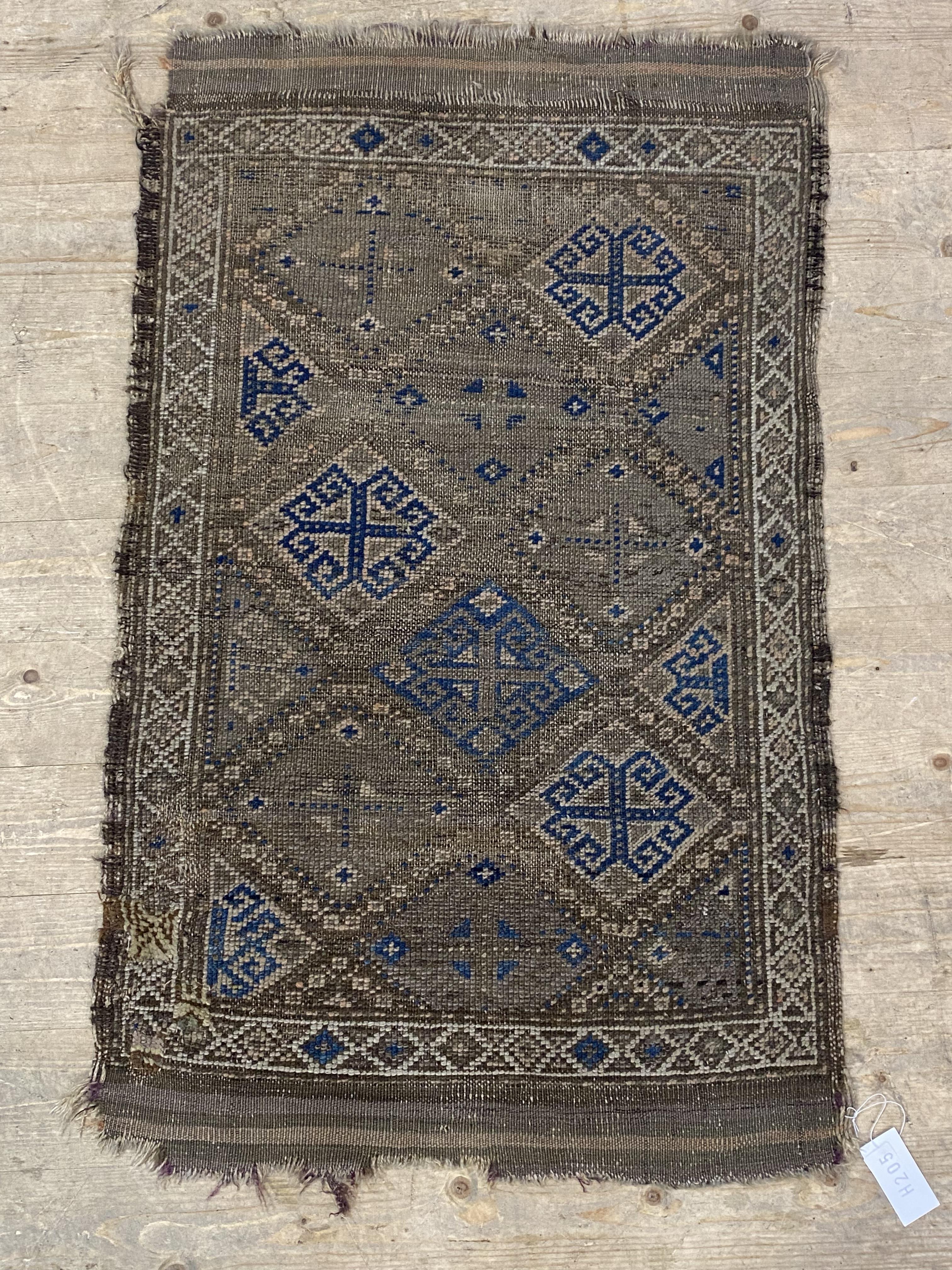 A small antique rug of geometric design 109cm x 65cm.