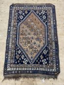 A South East Persian hand knotted rug, the blue field with hexagonal panel within a multi-line