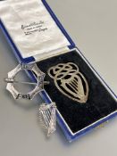 A silver celtic style harp brooch L x 4cm,  a white metal octagonal panel brooch with celtic