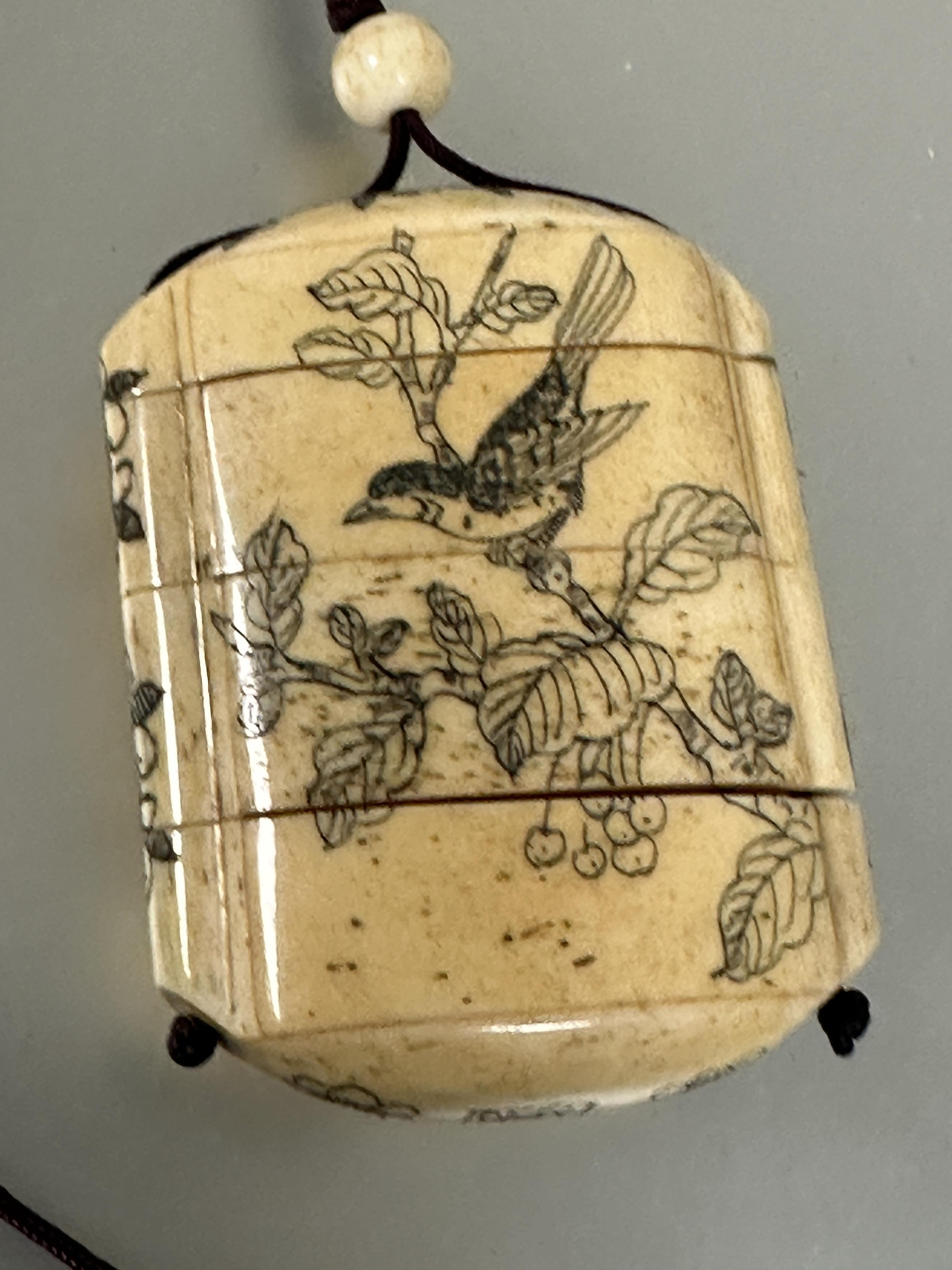 A modern Japanese style carved bone Inro mounted on burgundy cord and bead Ojime and four sections - Image 3 of 4