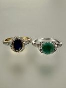 A 9ct gold sapphire and clear stone cluster ring the oval cut sapphire in rub over setting O/P 3.03g