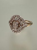 A 9ct rose gold ring, the center with nine claw set diamonds within two radiating rows of diamond