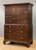 A George III tallboy chest on chest, the projecting cornice above a blind fret-carved frieze, fitted