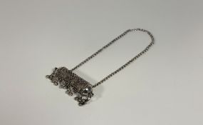 An Islamic white metal prayer scroll or Koran case, of cylindrical form, decorated in relief with