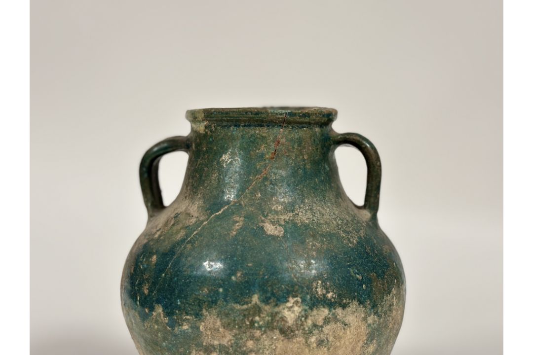 An Islamic, Kashan, glazed pottery twin-handled jar, probably 12th/13th century, with iridescent - Image 1 of 5