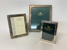 Three silver photo frames