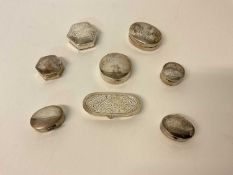 Eight silver pill boxes