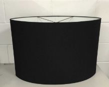 Two very large black oval lamp shades, 51cm high x 76cm wide and 45.5cm high x 56cm wide