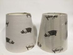 Pair of Emily Bond lamp shades decorated with pigs, 36cm high
