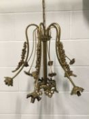Brass Ormolu Chandelier with flower garlands, together with a Black wrought iron chandelier. The fir