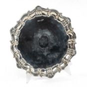 SOLID SILVER SALVER, acanthus leaf and shell border, raised on three feet, engraved cartouche with