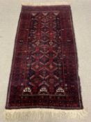 EASTERN WOOLEN RUG, red ground, repeating central diamond block pattern, multi bordered edge,