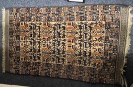 PERSIAN CREAM GROUND HANDMADE WOOL RUG, centerfield with birds and animals, geometric border, 143