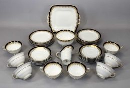 GEORGE JONES CRESCENT CHINA TEA SERVICE, cobalt blue band with gilded highlights, approx. 31