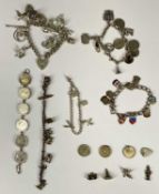 SIX SILVER & WHITE METAL CHARM/COIN BRACELETS together with additional charms, 3.2ozt (100.9gms),