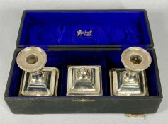EDWARD VII CASED THREE PIECE SILVER DESK SET, comprising pair of squat form candlesticks and