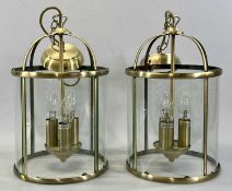 MODERN CYLINDRICAL PENDANT LANTERN LIGHT FITTINGS, a pair, brushed brass frames, curved clear